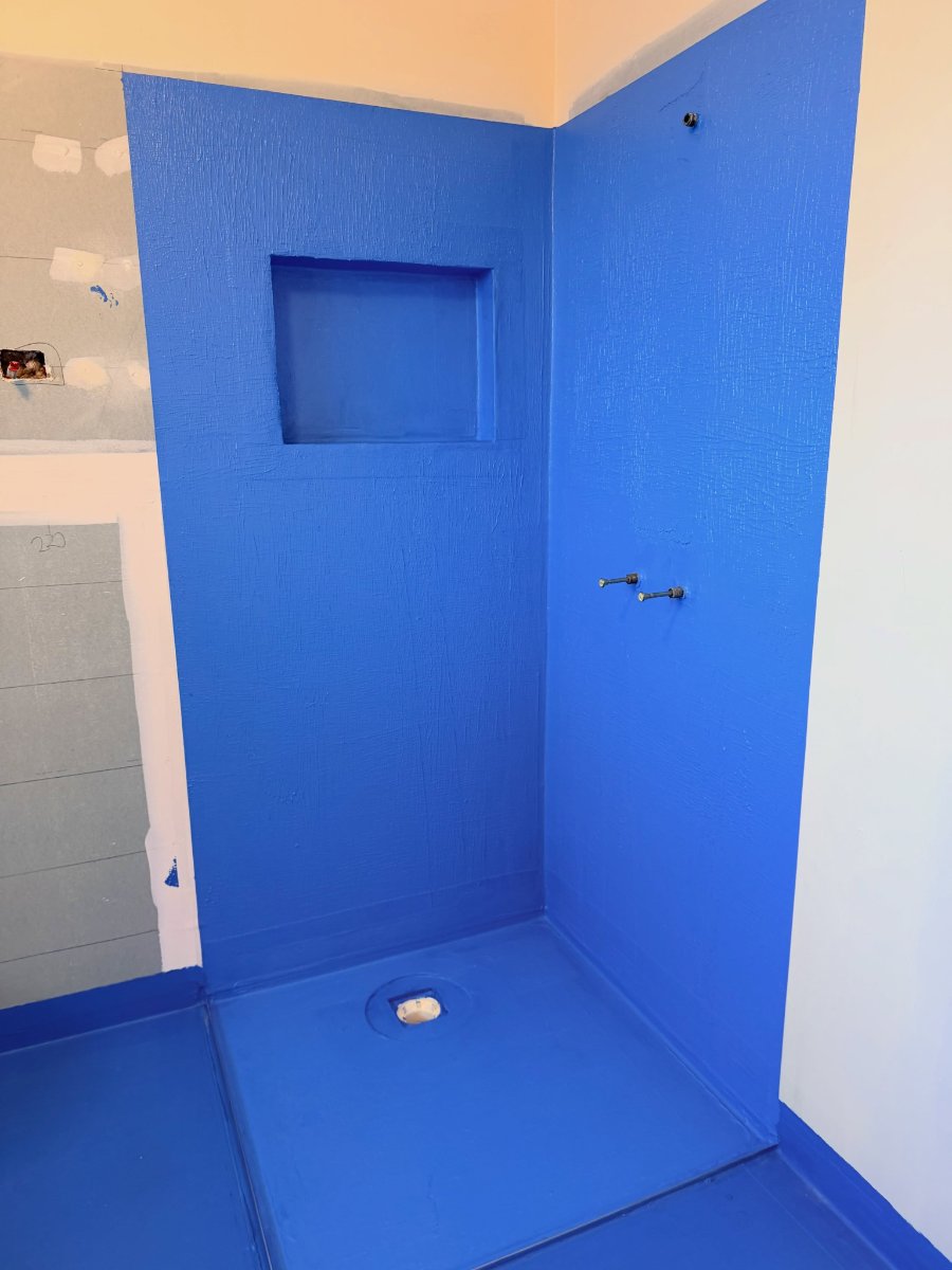 Shower corner with niche, fully coated in blue waterproofing membrane — photo by Melbourne Waterproofing