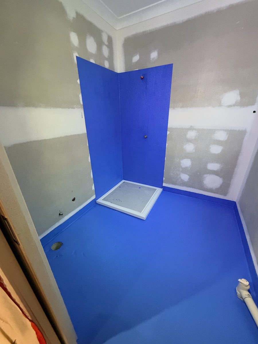Shower recess and floor sealed with blue waterproofing membrane, ready for tiling — photo by Melbourne Waterproofing